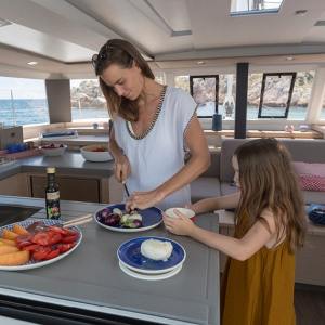 a person preparing food while standing in front of a window