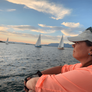 a woman sitting on a boat in a body of water
