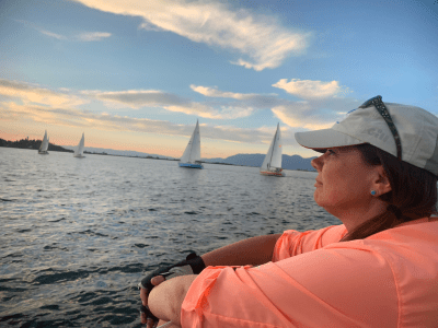 a woman sitting on a boat in a body of water