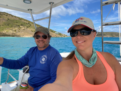 a man and a woman standing next to a body of water