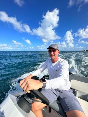 a person sitting in a boat on a body of water