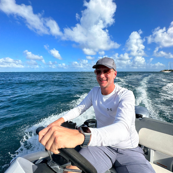 a man sitting in a boat on a body of water