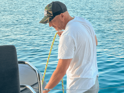 a man standing next to a body of water