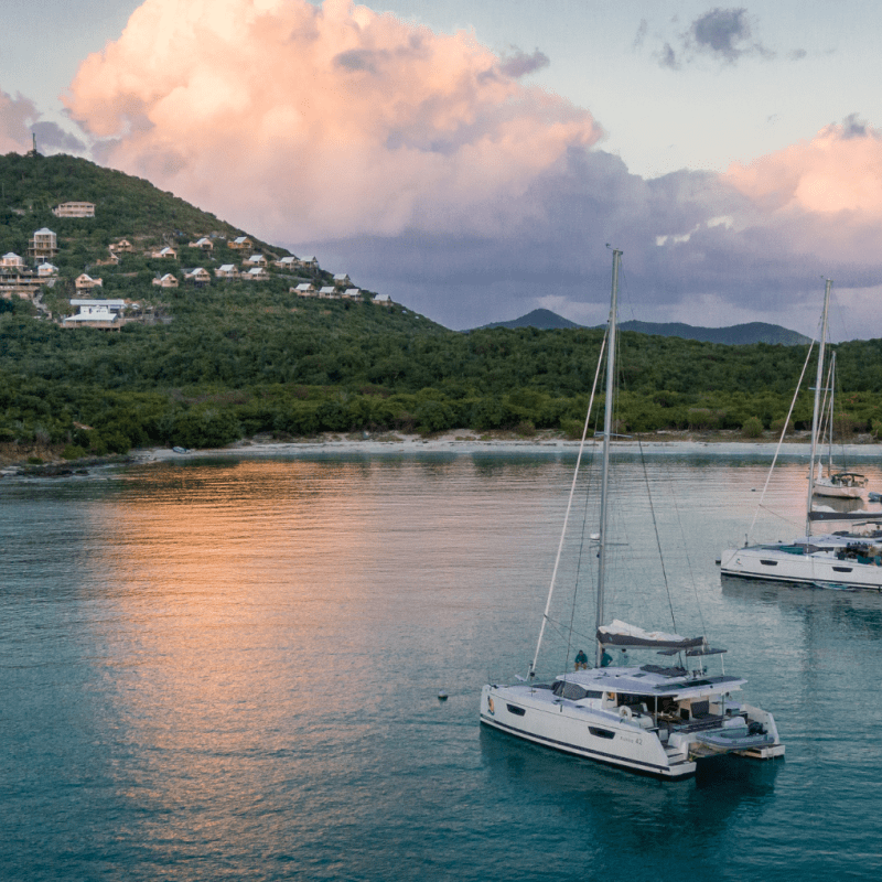 a small boat in a body of water with a mountain in the background
