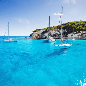 a blue and white boat sitting next to a body of water