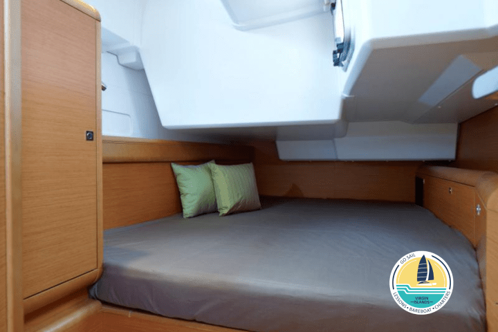 a bedroom with a bed and desk in a room