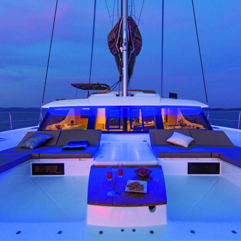 a blue and white boat sitting next to a body of water