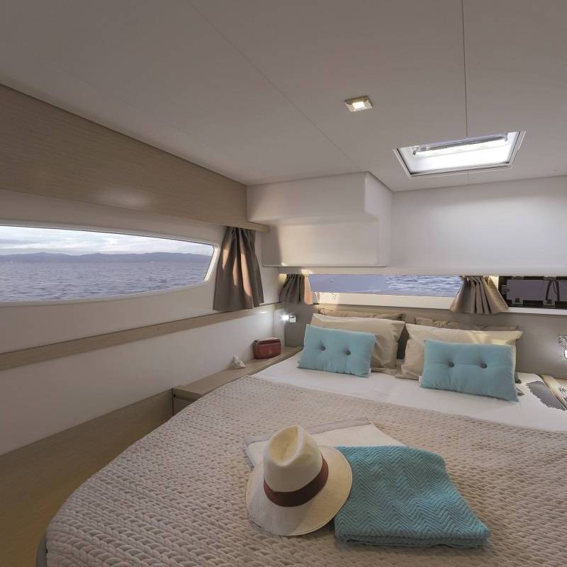 a bedroom with a bed and a mirror in a room