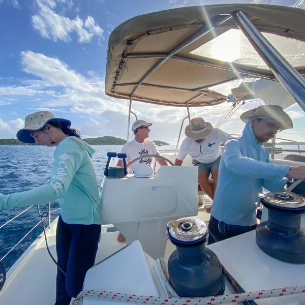 a group of people standing on a boat
