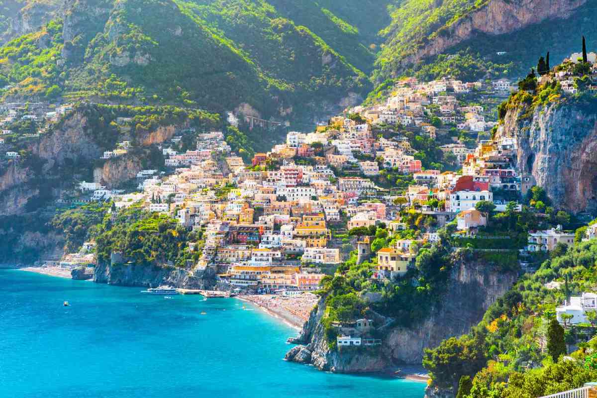 Amalfi-Coast a view of a body of water with a mountain in the background