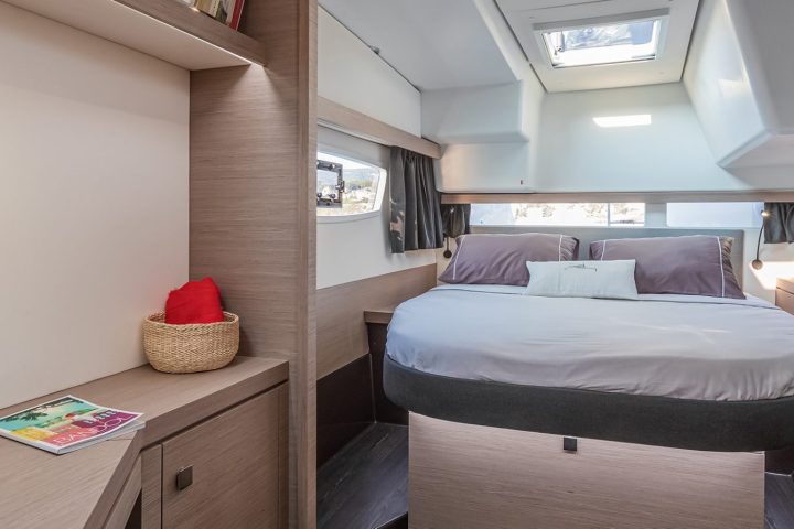 a bedroom with a bed and desk in a room