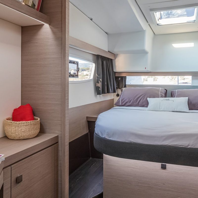 a bedroom with a bed and desk in a room