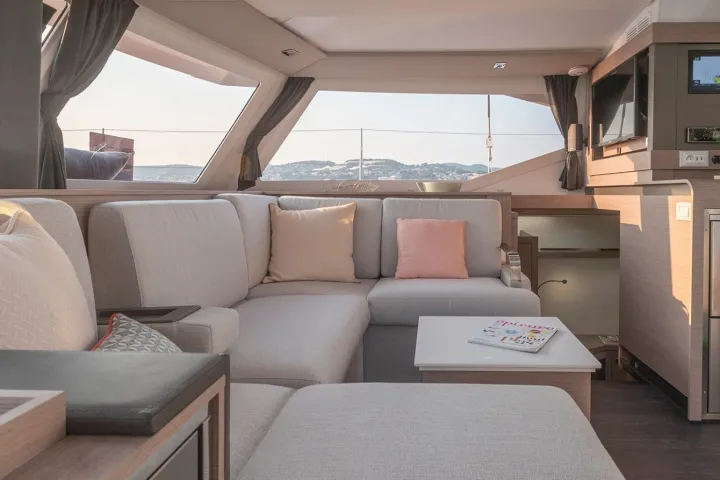 a living room filled with furniture and a large window