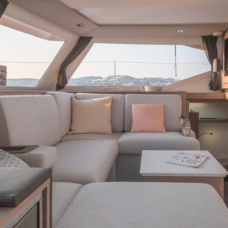 a living room filled with furniture and a large window