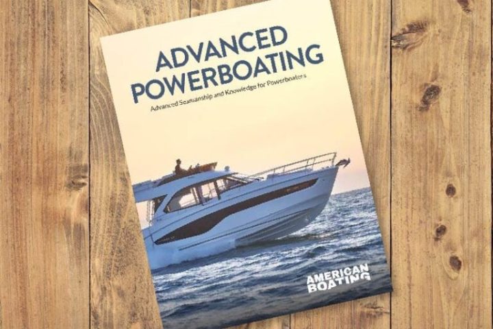 Book titled 'Advanced Powerboating' on wooden surface.