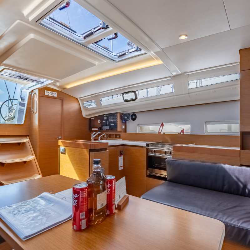Interior of a modern boat cabin with wooden finish and skylights.